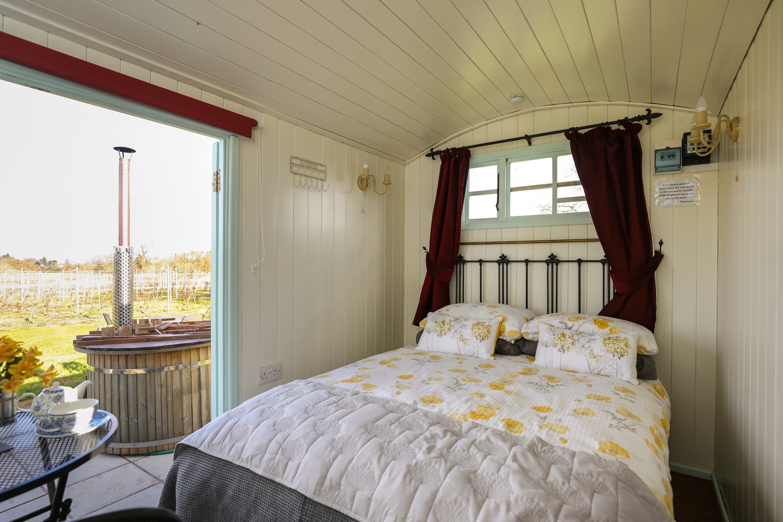Shepherd's hut interior with vineyard views and hot tub